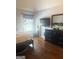 Bedroom with a bed, a window, hardwood floors, and a dresser with a television mounted on the wall at 1869 Schofield Dr, Hampton, GA 30228