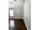Bedroom featuring neutral walls, hardwood floors, and a large window with blinds at 1869 Schofield Dr, Hampton, GA 30228
