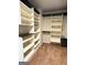 Walk-in closet with built-in shelving, cabinets, and organization for clothes and other belongings at 1869 Schofield Dr, Hampton, GA 30228