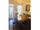 A wooden dining room table sits near a glass door and boasts a leather dining bench at 1869 Schofield Dr, Hampton, GA 30228