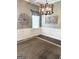 Dining room featuring decorative chandelier, neutral paint and trim, and large rug at 1869 Schofield Dr, Hampton, GA 30228