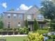 Beautiful brick home with manicured landscaping, including hydrangeas and evergreens, offers classic curb appeal at 1869 Schofield Dr, Hampton, GA 30228