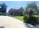 A stately brick home with manicured lawn and mature trees; driveway leads to attached garage at 1869 Schofield Dr, Hampton, GA 30228