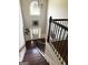 Foyer featuring staircase with iron spindles, chandelier, and large window above front door at 1869 Schofield Dr, Hampton, GA 30228