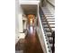 Open foyer with staircase, wood floors, built-in cabinets, and view of the front door at 1869 Schofield Dr, Hampton, GA 30228