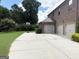 This home features a basketball hoop, a large driveway, and a three-car garage, perfect for active homeowners at 1869 Schofield Dr, Hampton, GA 30228