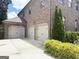 A three-car garage adds substantial parking and storage with established landscaping, enhancing curb appeal at 1869 Schofield Dr, Hampton, GA 30228