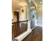 Hallway featuring hardwood floors and decorative trimwork leading to other rooms in the home at 1869 Schofield Dr, Hampton, GA 30228