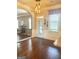 View of the hallway with hardwood floors, and open archways to the Gathering room at 1869 Schofield Dr, Hampton, GA 30228