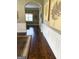 Entry hallway with hardwood floors and decorative trimwork leading to other rooms in the home at 1869 Schofield Dr, Hampton, GA 30228