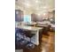 A well-lit kitchen with wooden floors, an island, granite countertops and dark cabinets at 1869 Schofield Dr, Hampton, GA 30228