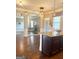 Open kitchen featuring a breakfast bar with granite countertops, hardwood floors and stainless steel appliances at 1869 Schofield Dr, Hampton, GA 30228