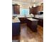 Well-equipped kitchen with granite countertops, dark wood cabinetry, and stainless steel appliances at 1869 Schofield Dr, Hampton, GA 30228