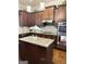 Lovely kitchen with wood cabinets, an island with granite countertops, and stainless steel appliances at 1869 Schofield Dr, Hampton, GA 30228