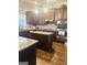 A beautiful kitchen boasts wooden floors, dark cabinets, stainless steel appliances and an island at 1869 Schofield Dr, Hampton, GA 30228