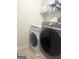 Modern laundry room with front loading washer and dryer units at 1869 Schofield Dr, Hampton, GA 30228