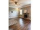 A cozy living room featuring hardwood floors, a stone fireplace, and neutral décor at 1869 Schofield Dr, Hampton, GA 30228