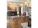 Open-concept living room showcasing hardwood floors, a view of the kitchen, and a playful atmosphere at 1869 Schofield Dr, Hampton, GA 30228