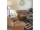 Cozy living room with a large sofa, chair, glass-top coffee table and decorative accents at 1869 Schofield Dr, Hampton, GA 30228