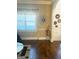 Inviting living room featuring hardwood floors, a large window, and elegant wall decor at 1869 Schofield Dr, Hampton, GA 30228