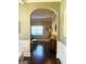 Open-concept living space with an arched entryway, hardwood flooring and natural light at 1869 Schofield Dr, Hampton, GA 30228