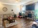 Inviting living room boasts hardwood floors, stone fireplace with large television, and comfortable seating at 1869 Schofield Dr, Hampton, GA 30228