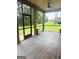 Screened-in porch featuring durable floors, a ceiling fan, and view of the yard at 1869 Schofield Dr, Hampton, GA 30228
