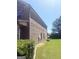 Brick home side yard with green lawn, tidy landscaping, and a well-maintained exterior at 1869 Schofield Dr, Hampton, GA 30228