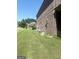 Spacious side yard featuring a well-maintained lawn and brick facade, close to nearby homes at 1869 Schofield Dr, Hampton, GA 30228