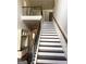 Staircase with white risers, wood treads, iron spindles, and a built-in mudroom cabinet at 1869 Schofield Dr, Hampton, GA 30228