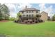 Expansive backyard with a manicured lawn and mature trees, ideal for outdoor activities and relaxation at 4818 Moon Hollow Ct, Buford, GA 30519