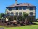 Large backyard with deck, landscaping, covered patio, and well-maintained lawn at 4818 Moon Hollow Ct, Buford, GA 30519