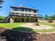 A spacious yard with deck, covered patio and a round stone fire pit at 4818 Moon Hollow Ct, Buford, GA 30519