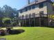 Exterior deck and landscaped backyard with lawn and mature trees at 4818 Moon Hollow Ct, Buford, GA 30519