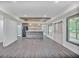 Finished basement boasting a bar area with wooden accents, gray flooring and natural light from windows at 4818 Moon Hollow Ct, Buford, GA 30519