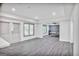 Spacious basement featuring light gray wood flooring, two windows, and an open concept living area at 4818 Moon Hollow Ct, Buford, GA 30519