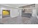 Finished basement with a gray bar area, modern lighting fixtures, and a cozy seating nook with shelving, perfect for entertaining at 4818 Moon Hollow Ct, Buford, GA 30519