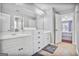 Bathroom with white cabinets, double vanity sinks, and tile flooring at 4818 Moon Hollow Ct, Buford, GA 30519