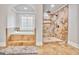 Luxurious bathroom with a tub and walk-in shower with stone tile and neutral flooring at 4818 Moon Hollow Ct, Buford, GA 30519