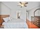 Bedroom with a Queen bed, wood dresser, and ceiling fan at 4818 Moon Hollow Ct, Buford, GA 30519