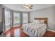 Bedroom with a Queen bed, ceiling fan, and multiple windows at 4818 Moon Hollow Ct, Buford, GA 30519
