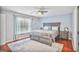 Bedroom with a gray bed, ceiling fan and large window at 4818 Moon Hollow Ct, Buford, GA 30519