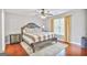 Cozy bedroom featuring a Queen bed, ceiling fan, and wood floors at 4818 Moon Hollow Ct, Buford, GA 30519