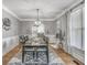 Elegant dining room with hardwood floors and modern light fixture at 4818 Moon Hollow Ct, Buford, GA 30519