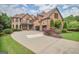 Beautiful two-story brick home featuring a large driveway and well-maintained landscaping at 4818 Moon Hollow Ct, Buford, GA 30519