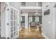Bright foyer with hardwood floors leads to an open-concept living area with coffered ceilings and an abundance of natural light at 4818 Moon Hollow Ct, Buford, GA 30519