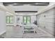 Finished basement game room with a ping pong table, wooden beams and decorative wall paneling at 4818 Moon Hollow Ct, Buford, GA 30519