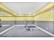 Home gym showcasing a treadmill, rowing machine, rubber flooring and two tone color scheme walls at 4818 Moon Hollow Ct, Buford, GA 30519