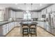 Modern kitchen featuring white cabinets, granite countertops, and stainless steel appliances at 4818 Moon Hollow Ct, Buford, GA 30519