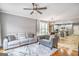 Bright, open concept living area with hardwood floors connects to the dining area and kitchen at 4818 Moon Hollow Ct, Buford, GA 30519